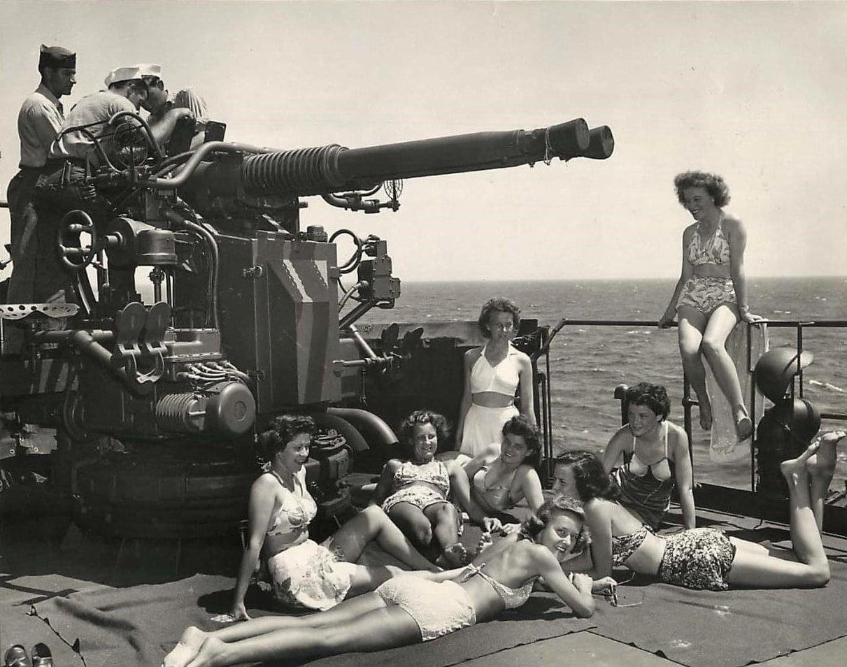 US army Nurses sunbathing next to a twin 40mm on a Coast Guard troop ship returning from Europe, 1945.jpg