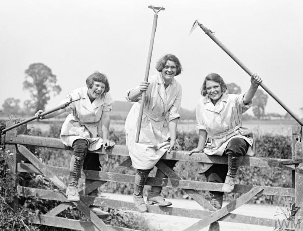 Land girls climbing over a gate on a British farm. 1916.jpg