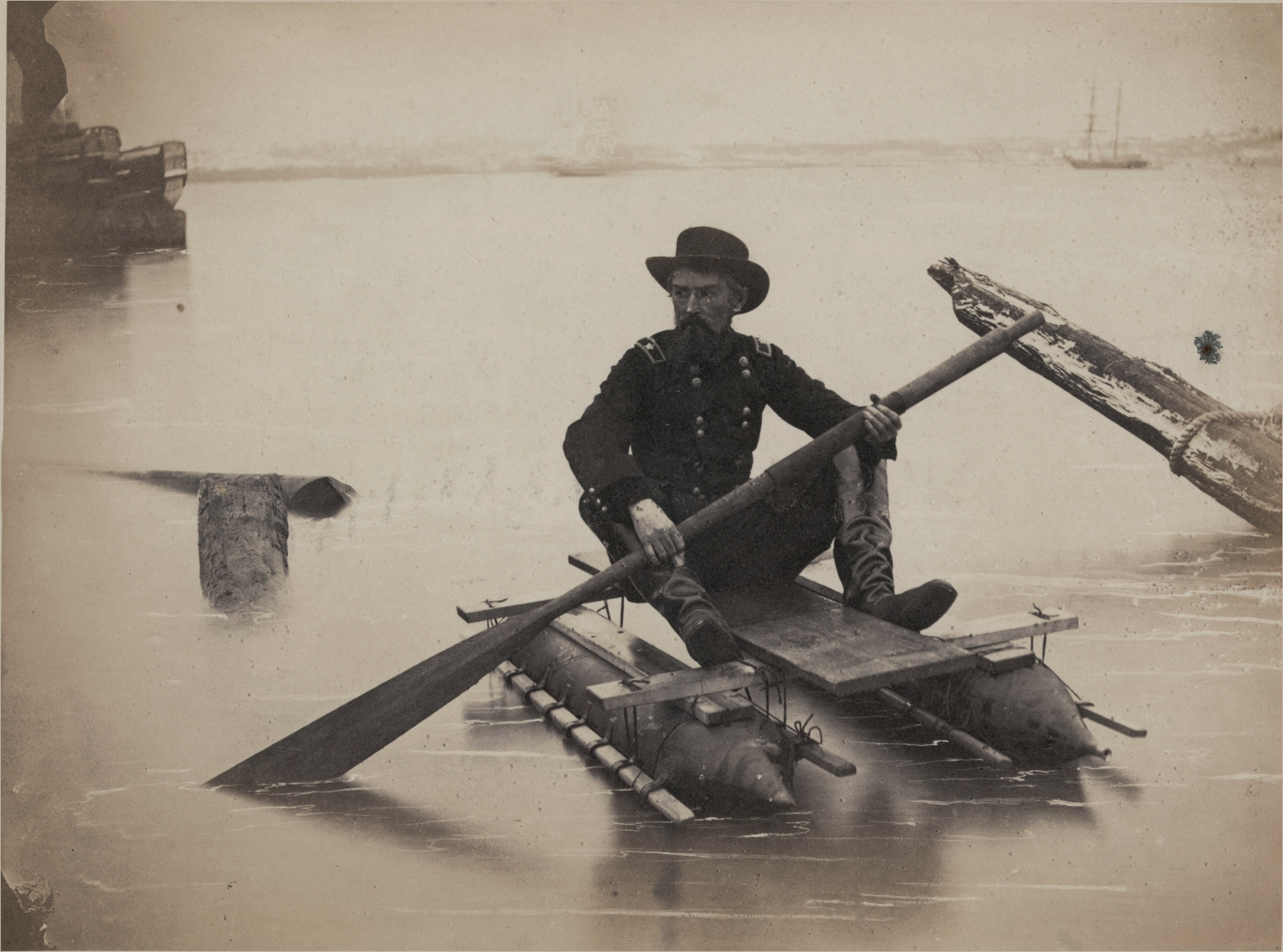 civil war engineer in a one-man pontoon boat that he invented for bridge inspection, 1860s.jpg