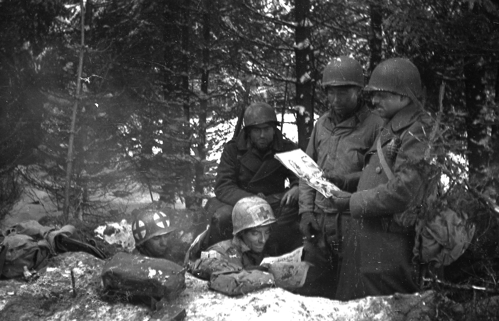 American soldiers reading a comic book during the Battle of the Bulge, Belgium, January 1945.jpg