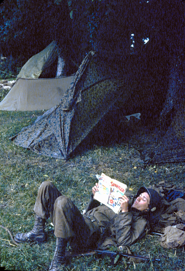 Private Ernest Dandou reads Sparkler Comics #33 at paratrooper camp, Georgia, 1944.jpg