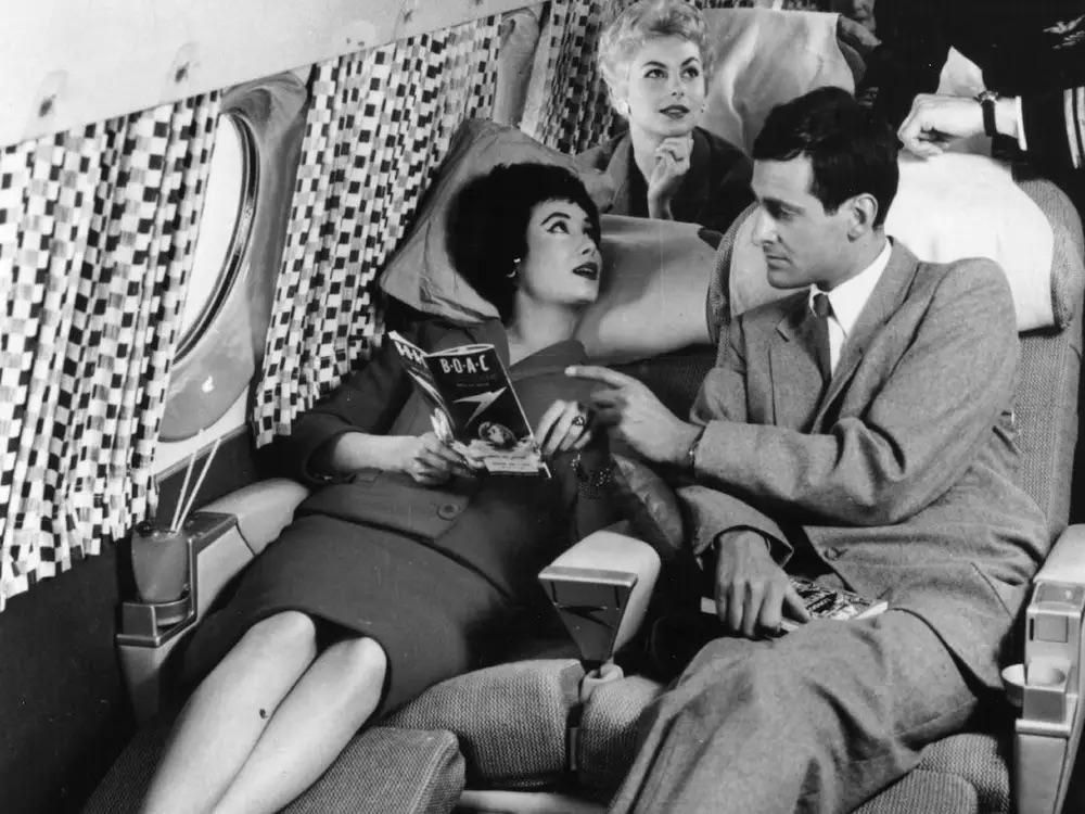 Passengers relaxing in lie-flat airplane seats in the 1950s.jpg
