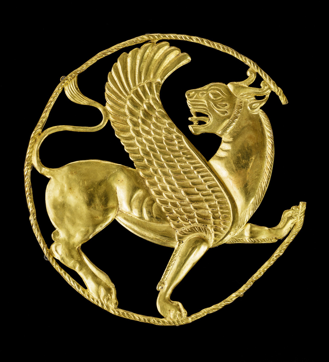 Decorative Achaemenid Gold roundel of a marchant winged lion, 550-330 B.C. Hamadan Province, Iran.jpg