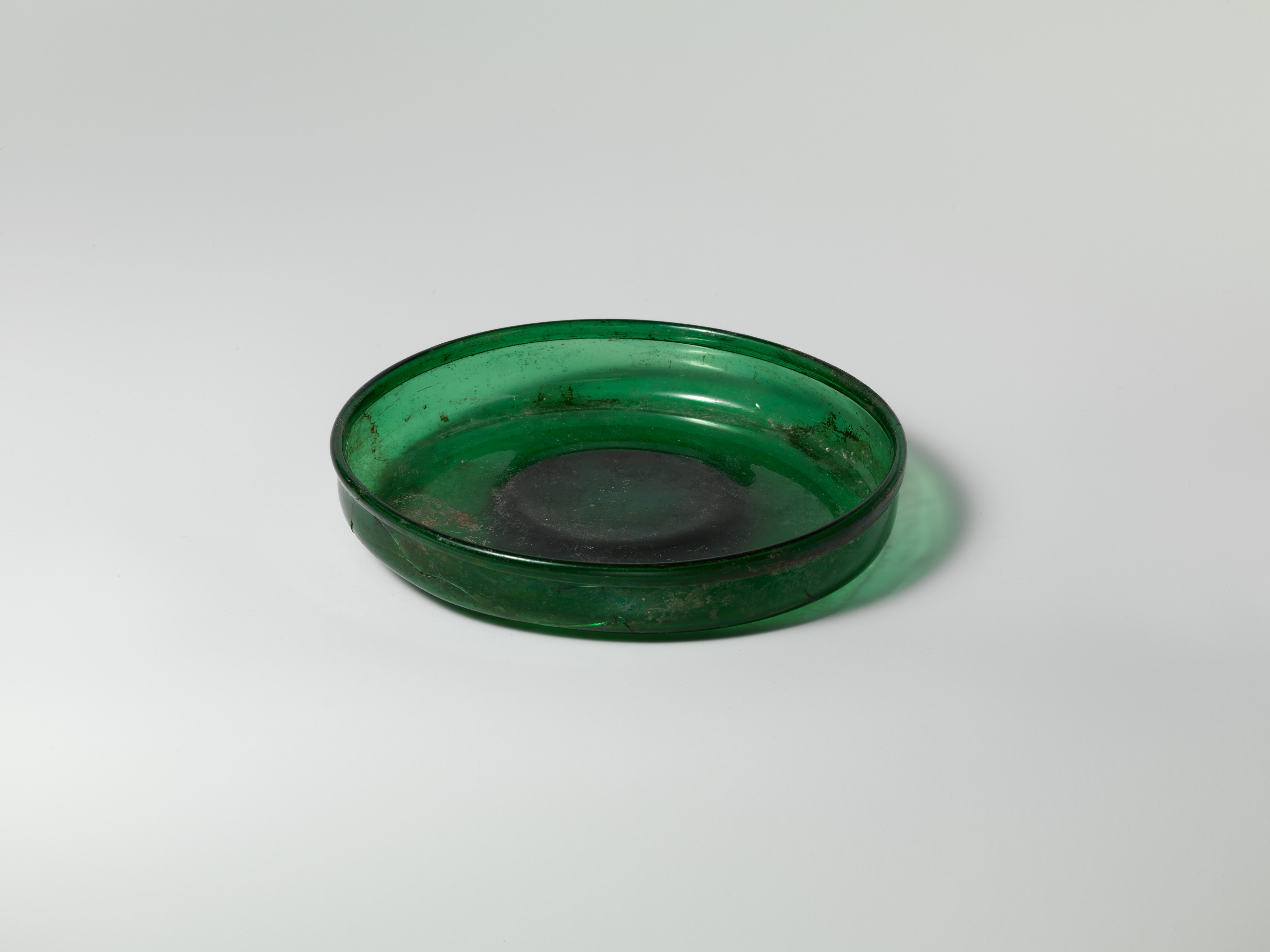 Ancient Roman green glass dish, c. 1st century CE.jpg