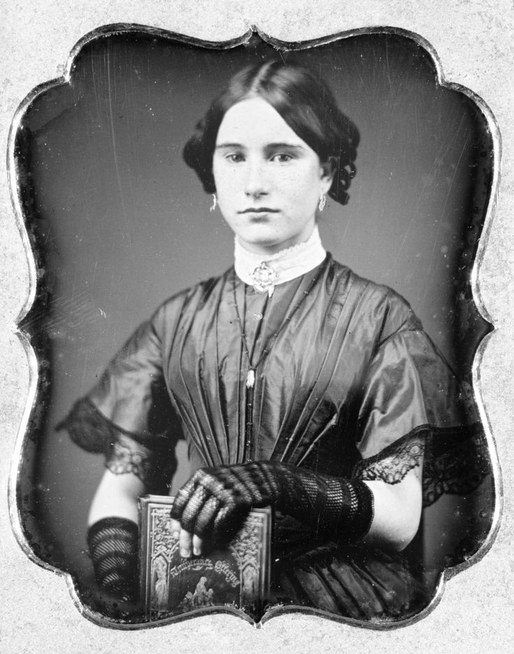 American daguerreotype of a young woman posing with a copy of the book The Sons of Temperance Offering for 1851, probably taken the same year. Library of Congress.jpg
