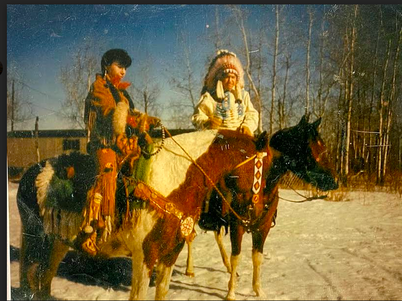 My Mom and Grandfather in the 80's riding horses in their regalia. My grandfather was Chief at the time.png