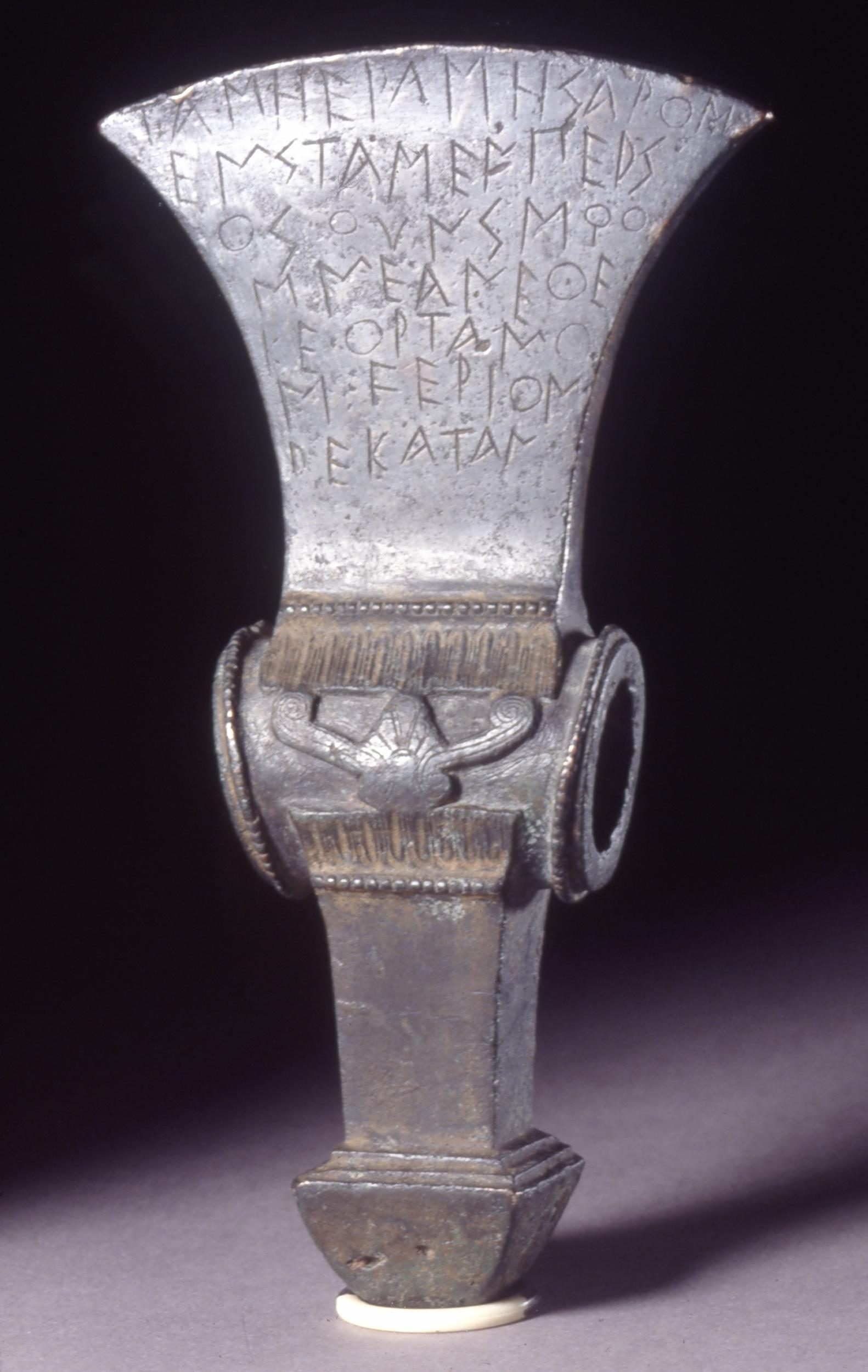 Bronze ceremonial axe head with greek inscription-dedication to 'Hera of the plains'. Sybaris-520 BCE ca. British museum.jpg