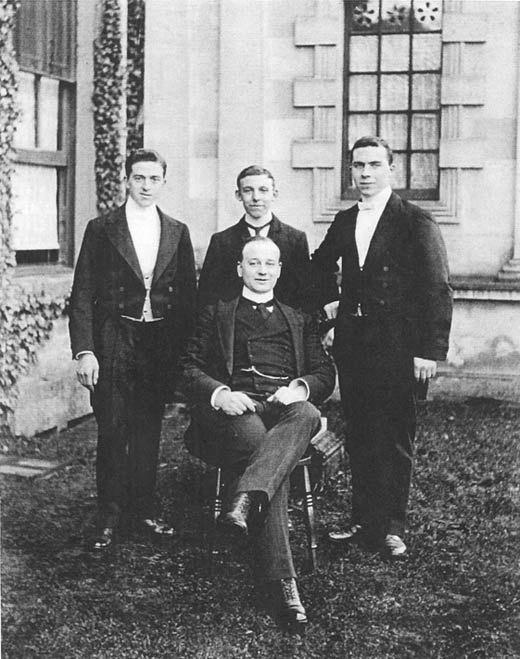 Butler_seated_with_3_footmen_of_Lackham_house.c.1900.jpg