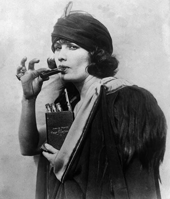 1925 Somewhere in Manhattan a woman drinks booze from bottles hidden in a book entitled Four Swallows.jpg