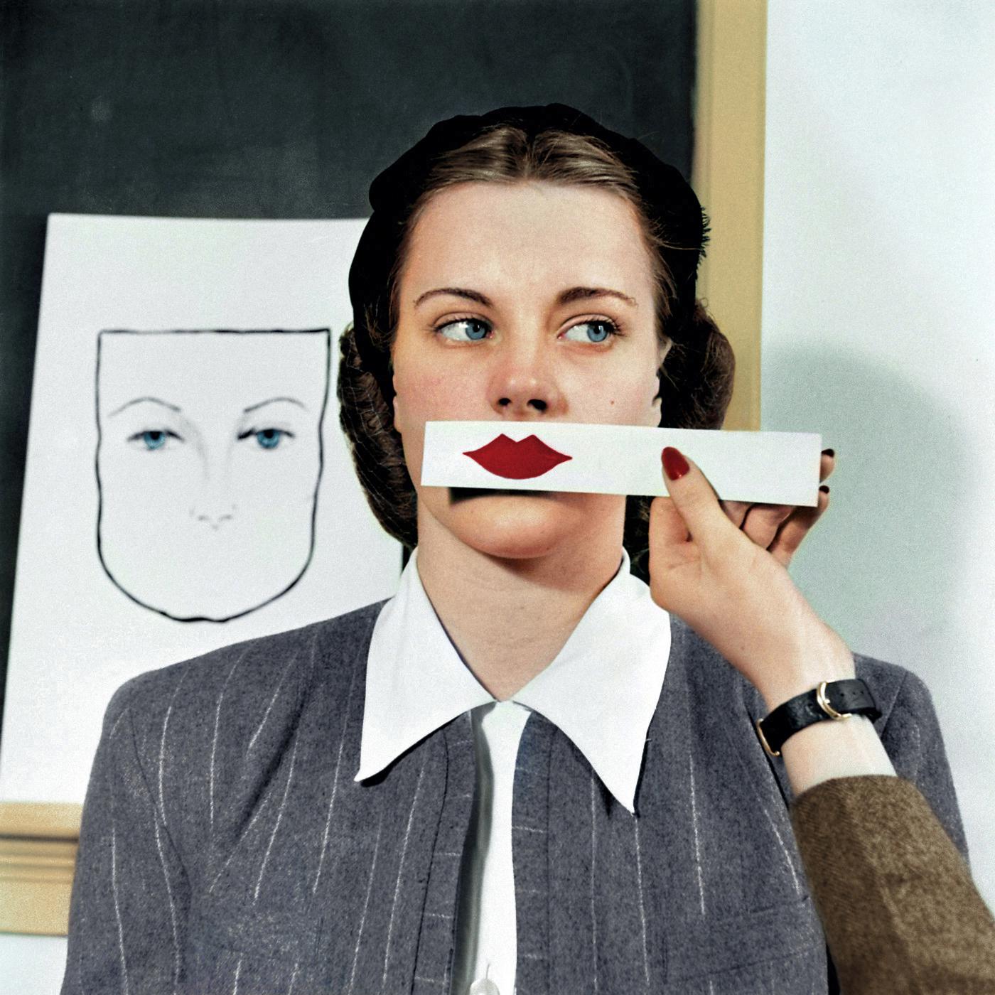 A woman samples different shades of lipstick on a strip of paper at Stephens College in Columbia, Missouri, 1945.jpg