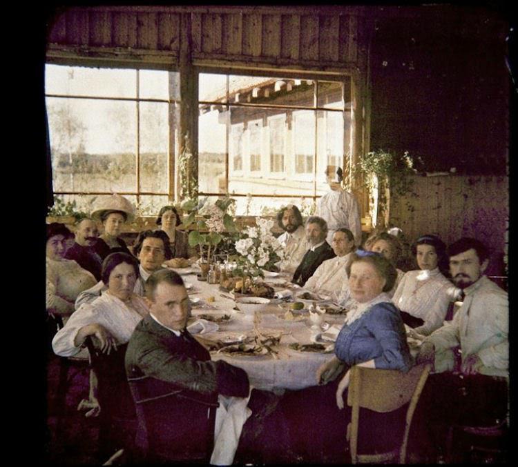 An autochrome color photograph of a dinner party at the home of writer Leonid Andreyev (bearded at back right), Vammelsuu, (Serovo) Gulf of Finland, 1912.jpg