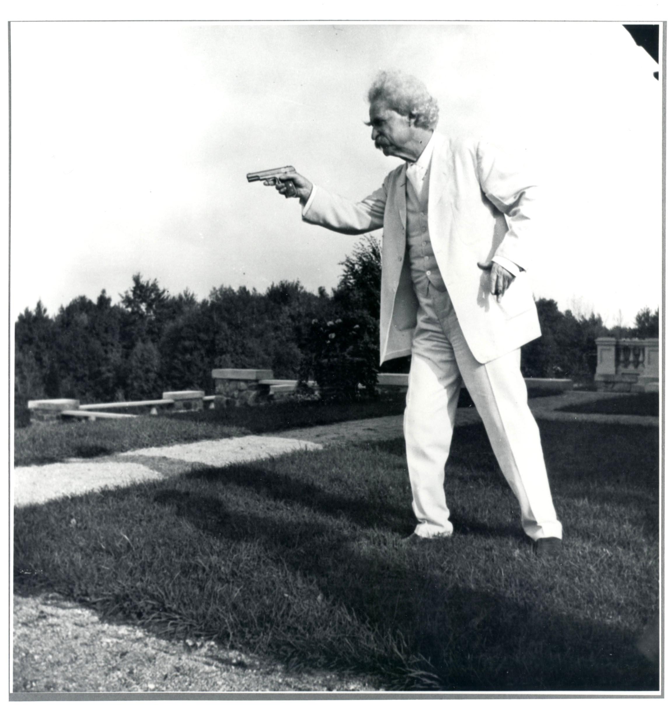 Mark Twain with a pistol and eyebrows, in 1908.jpg