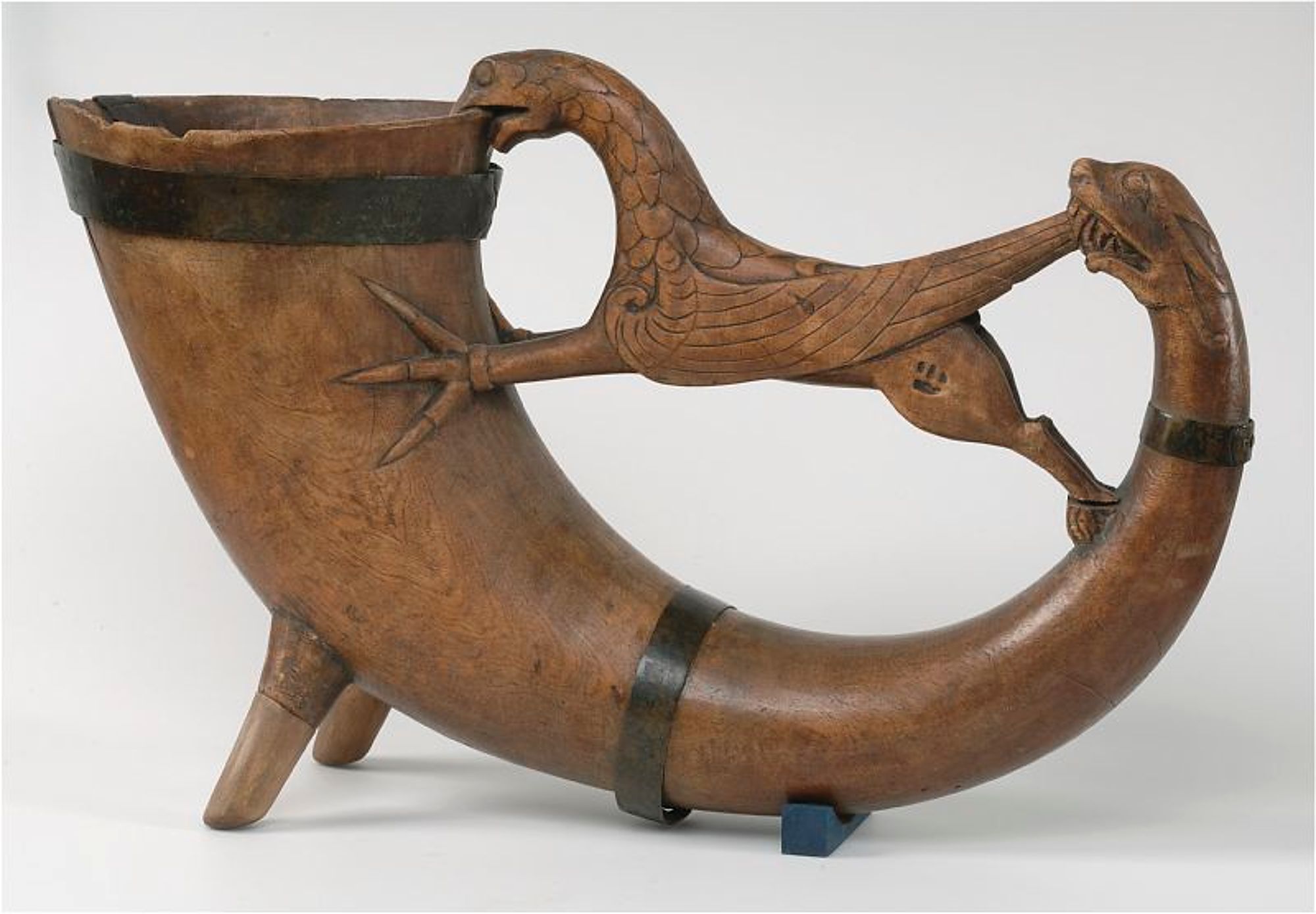 A medieval Swedish drinking horn made from birch wood with carved figures of a griffin and dragon, likely from the mid-13th to mid-14th centuries.jpg