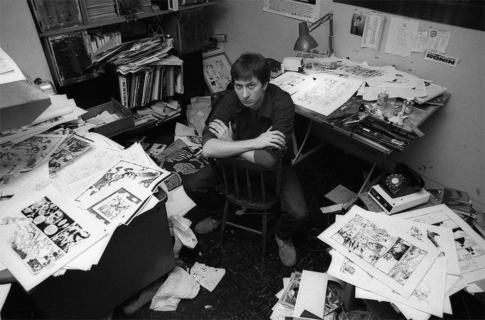 Frank Miller (best known for Daredevil, Wolverine, Ronin, The Dark Knight Returns, Sin City, 300, and more) in his messy personal office, 1983.jpg