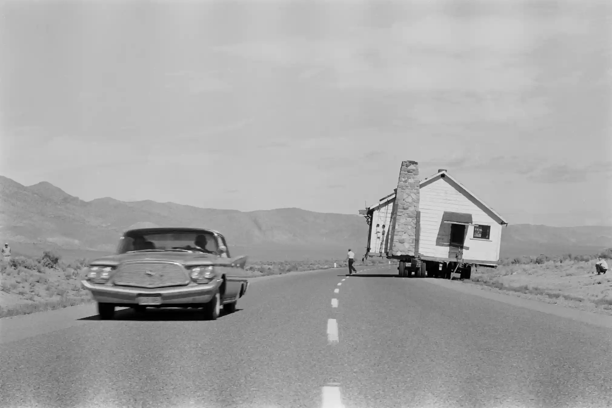 1960-a-house-being-transported-on-a-trailer-along-a-road-in-Nevada..jpg