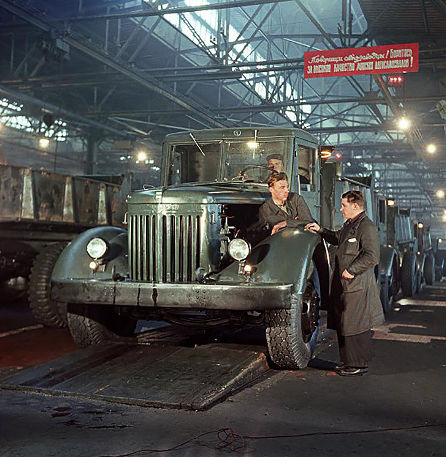 Factory workers attending to the production of dump trucks at an automobile plant in Minsk, Byelorussian SSR, Soviet Union (present day Belarus), 1953.jpg