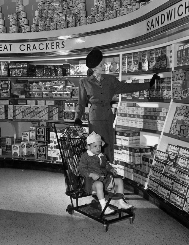 [1945] This impeccably dressed woman shopping for groceries with her son.JPG