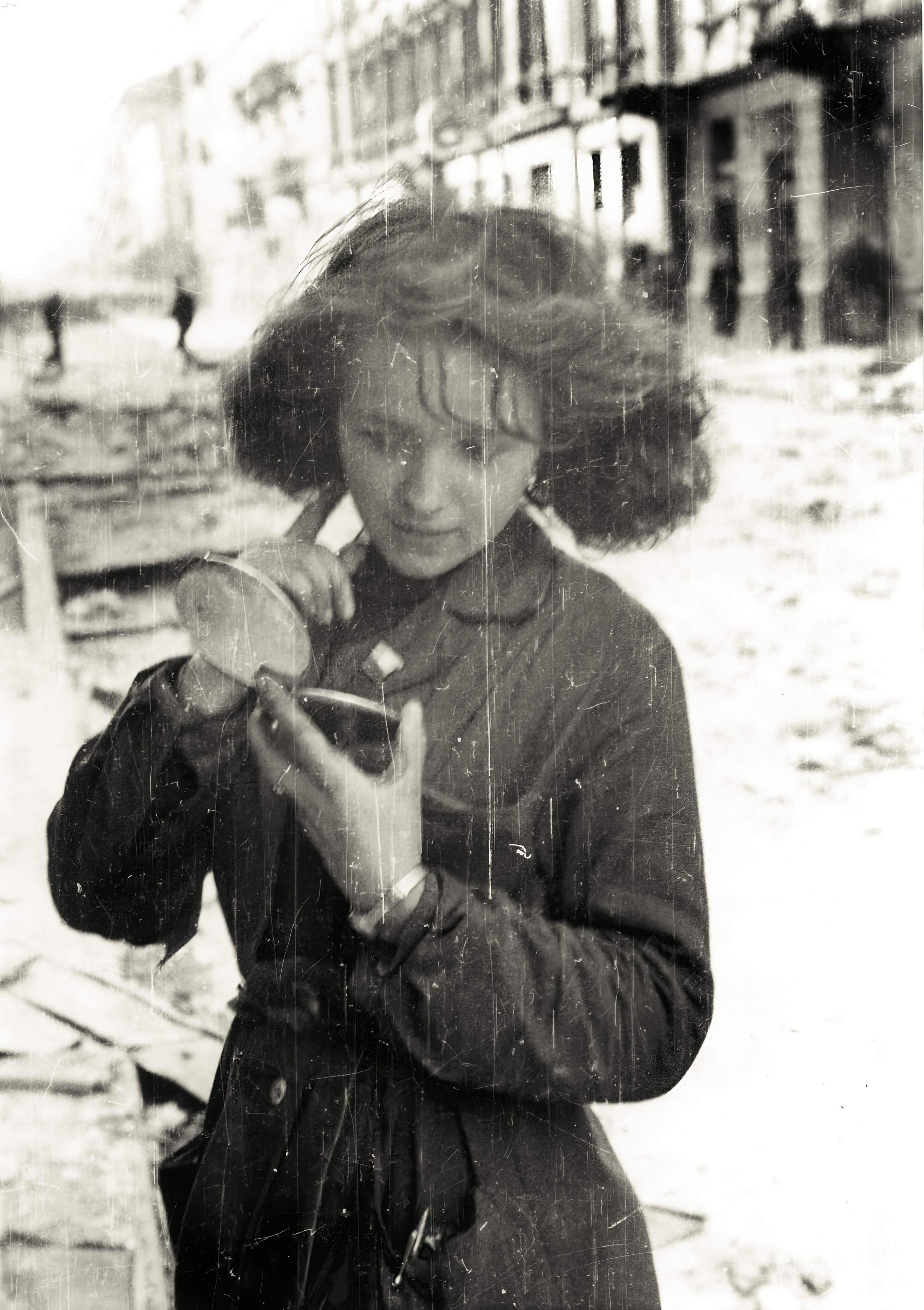 Woman with a mirror after an air raid during the horrendous 63 day Warsaw Uprising, 1944.jpg