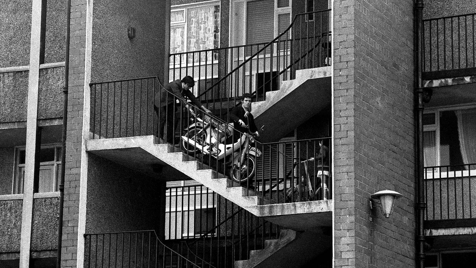 Bringing a Honda C50 down the stairs. Dublin, 1969.jpg