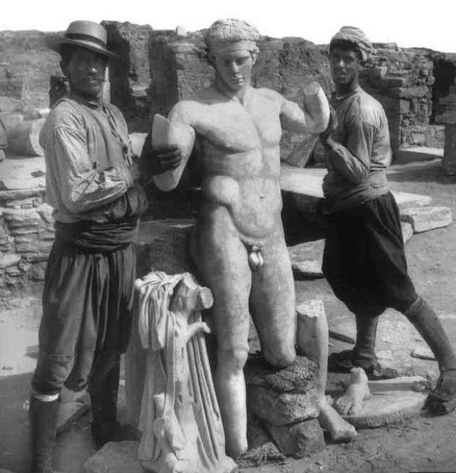 2,000 year-old statue of the Diadumenos, supported by two Mykonian workers, uncovered on the Greek island of Delos in 1894.jpg