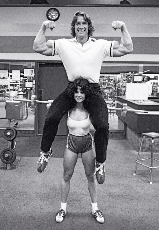 Arnold Schwarzenegger sits on the shoulders of bodybuilder and future star of Playboy magazine Lisa Lyon. USA , 1979.jpg