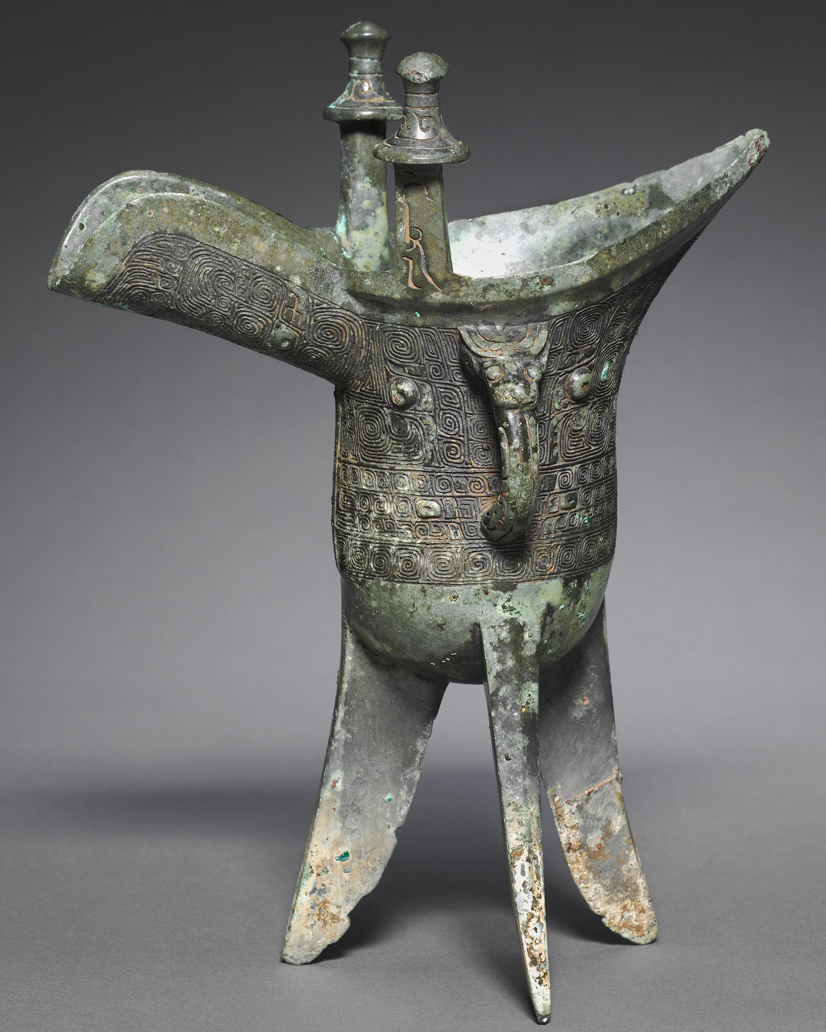 3,200-year-old bronze wine goblet on three legs, with spiral textures. China, Shang dynasty, 1200 BC.jpg