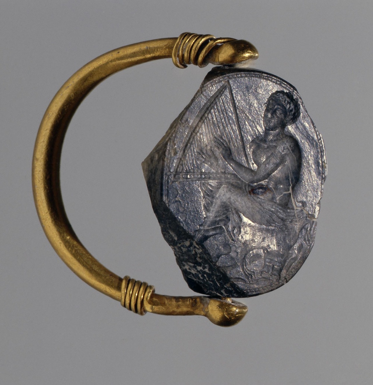 A gold ring with scaraboid flint, engraved with a harp player. From the Bosporan Kingdom, 400's BC.jpg