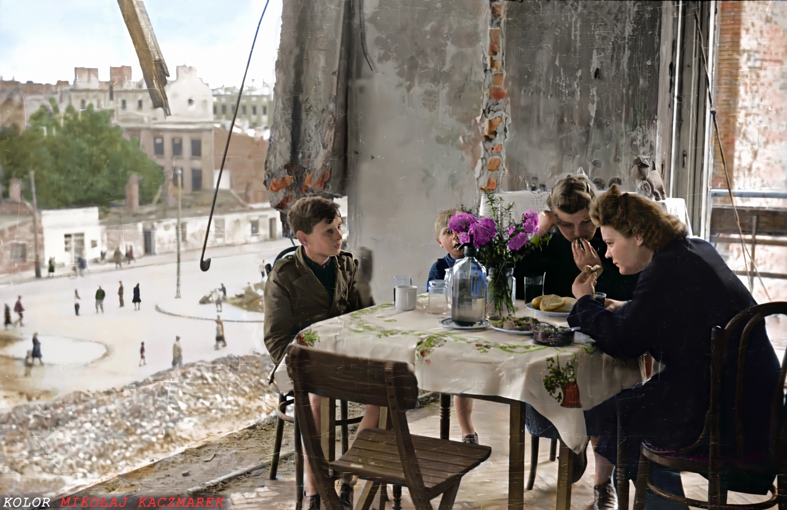 A family sitting down to a meal in post-war Warsaw. 1945. Karol Szczecinski.jpg