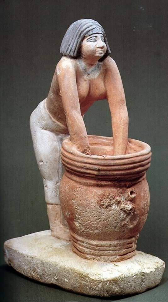 A painted limestone statuette of a woman making beer. Ca. 2494-2345 BCE, now housed at the Egyptian Museum in Cairo.jpg