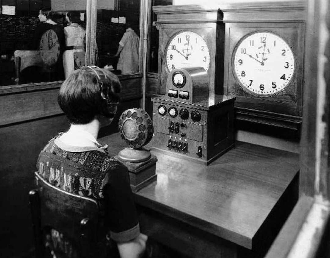 A woman working for the phone company at her post as the Time Lady, announcing the time live with each phone call that comes in, 1930s.jpg