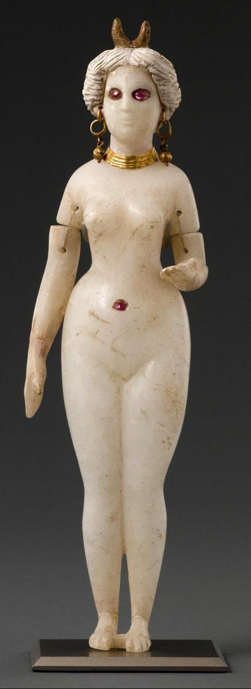 A statuette of a standing nude goddess made from alabaster, stucco, gold and rubies. From Babylon in Iraq, 1st century BCE–1st century CE, now housed at the Louvre Museum.jpg