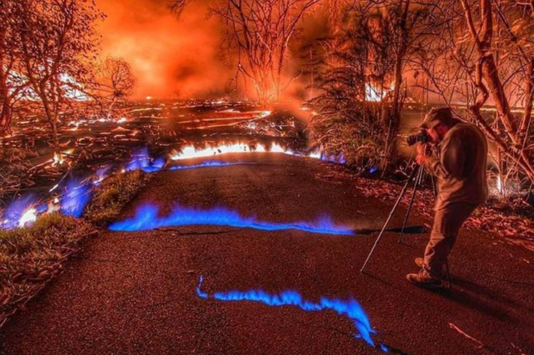 During the Kilauea volcano eruption in Hawaii in May 2018, photographer Brad Lewis captured this impressive shot of methane flames emerging from fissures along the road.png