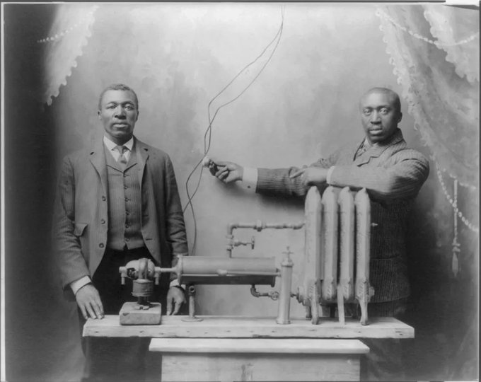 The inventor of the first friction radiator, Charles Baker (left), and his assistant demonstrating the invention, 1906.jpg