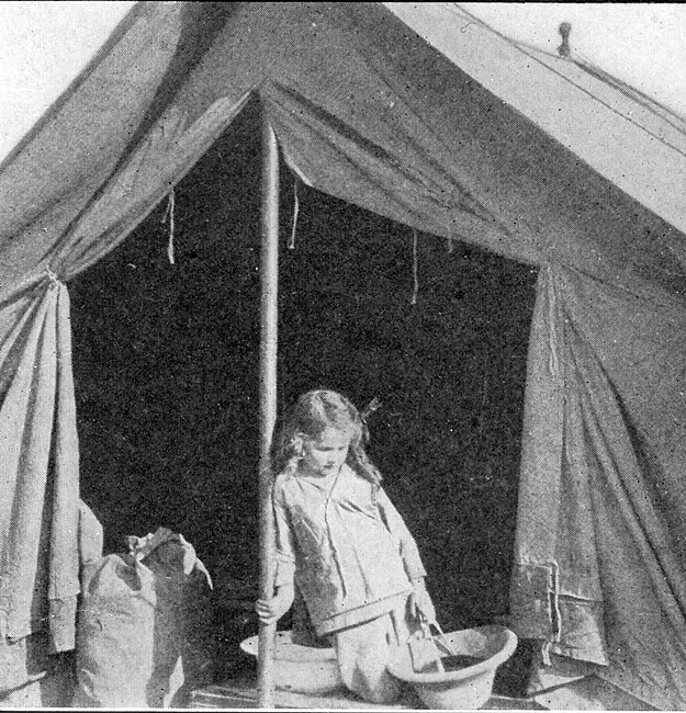 Six-year-old Alice in front of her tent, in her traveling clothes.jpg