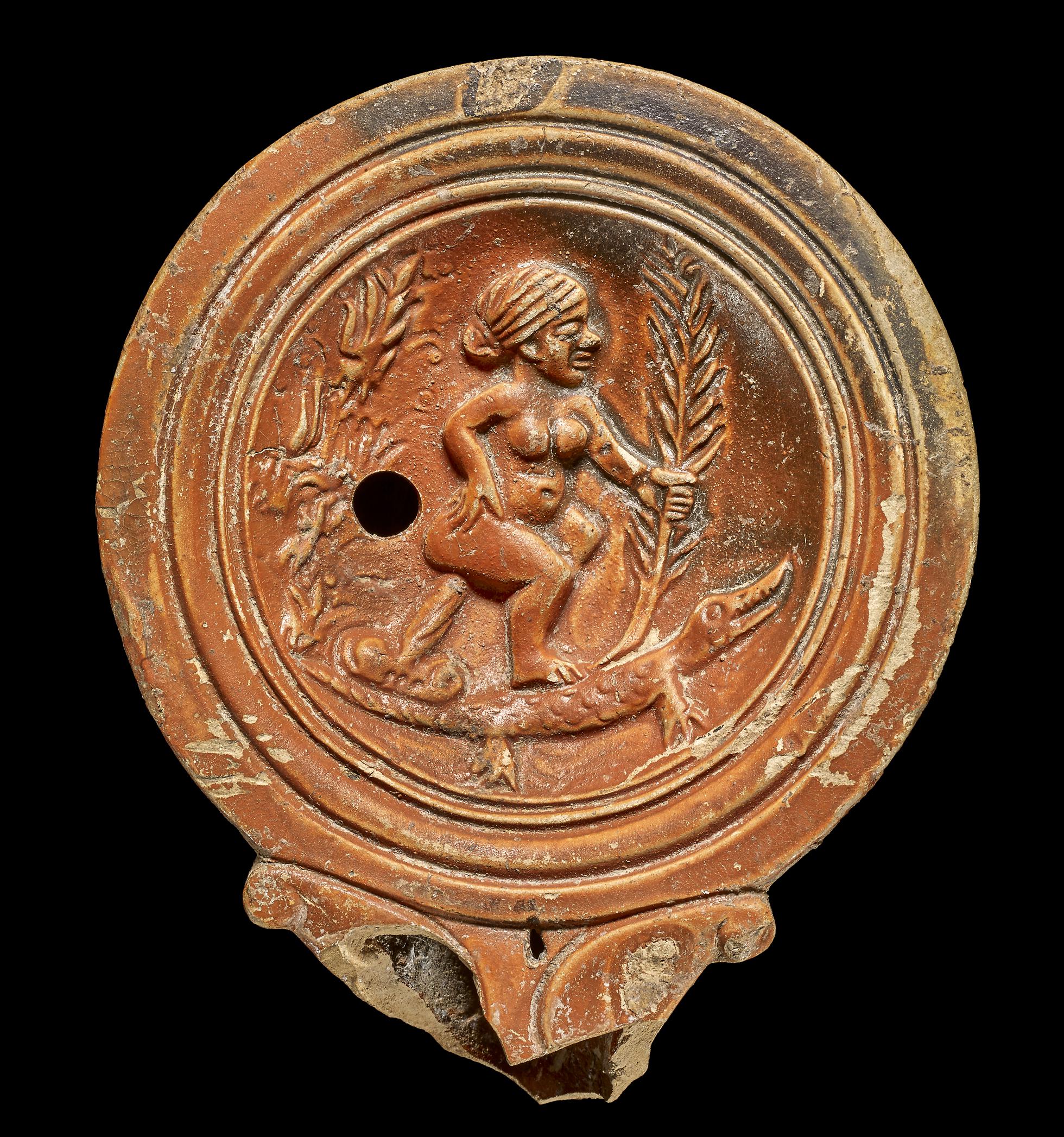 A Roman terracotta oil lamp, probably an obscene caricature of Cleopatra. After her death in 30 BCE, Octavian began a campaign to discredit the Queen of Egypt. Italy, 40-80 CE.jpg