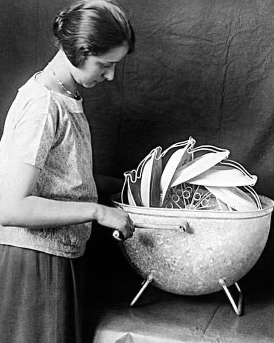 A woman demonstrating a portable manual dishwasher. 1929. Germany.jpg