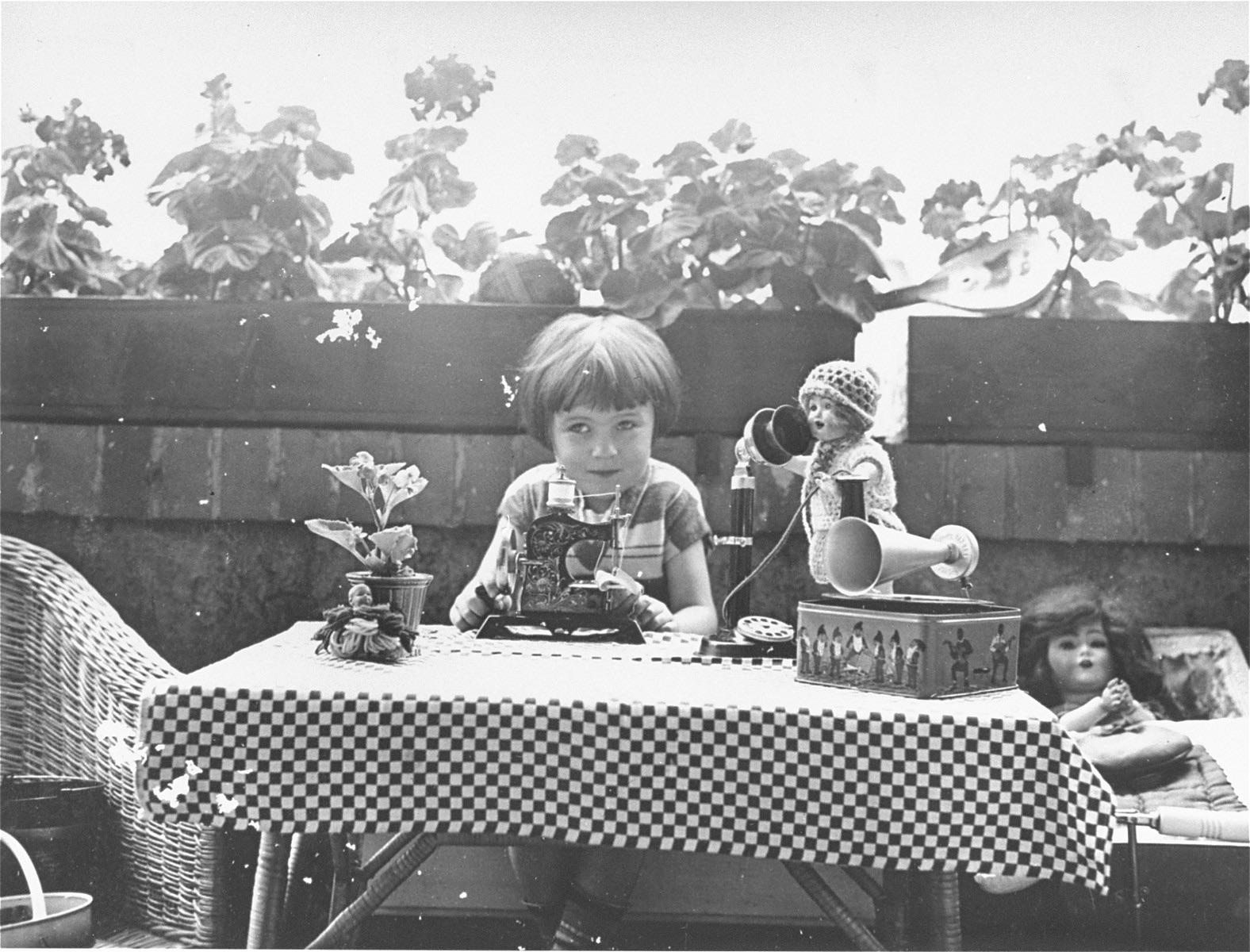 Berta sits with some toys on the terrace outside her parents’ home in Leipzig, Germany. 1928.jpg