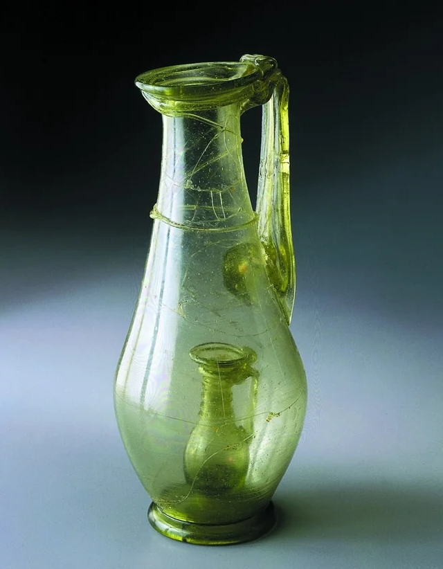 Roman glass jug with a smaller glass jug inside ~ a so called joke jar that shows the skill of the glassmaker. Probably made in workshop in Cologne, found in burial in Stein am Rhein, #Switzerland, 4th c. AD..jpg