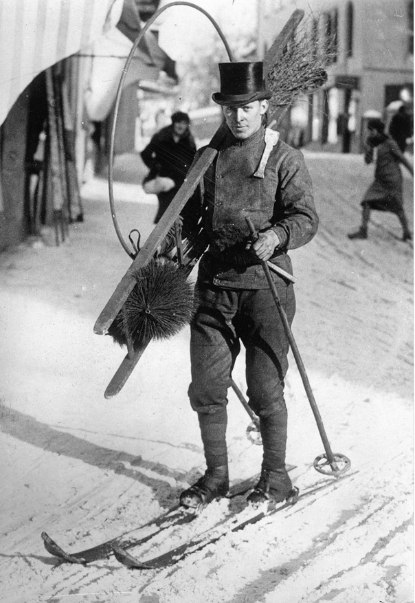 Chimney sweep in the traditional black top hat skis to work in Saint Moritz, Switzerland, circa 1935.png