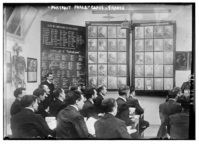 A class studies the Bertillon method of criminal identification, based on measuring body parts. Paris, France, ca. 1910s.jpg