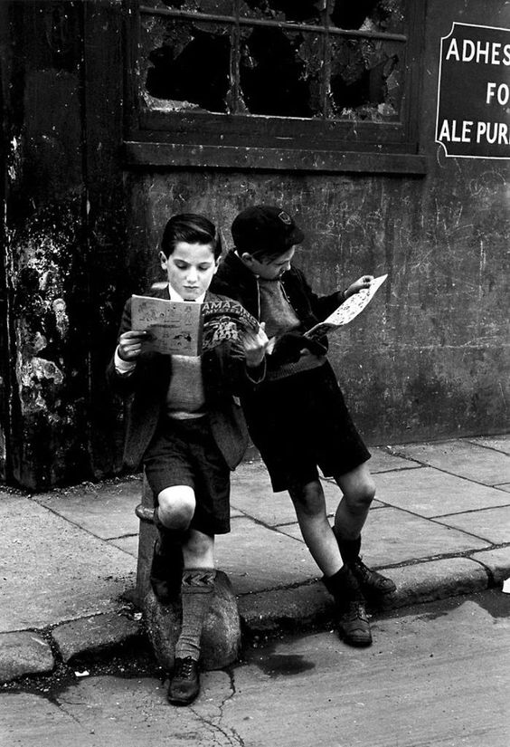 Two Boys Engrossed In Their Comic Books, Outside On The Street, 1952.jpg
