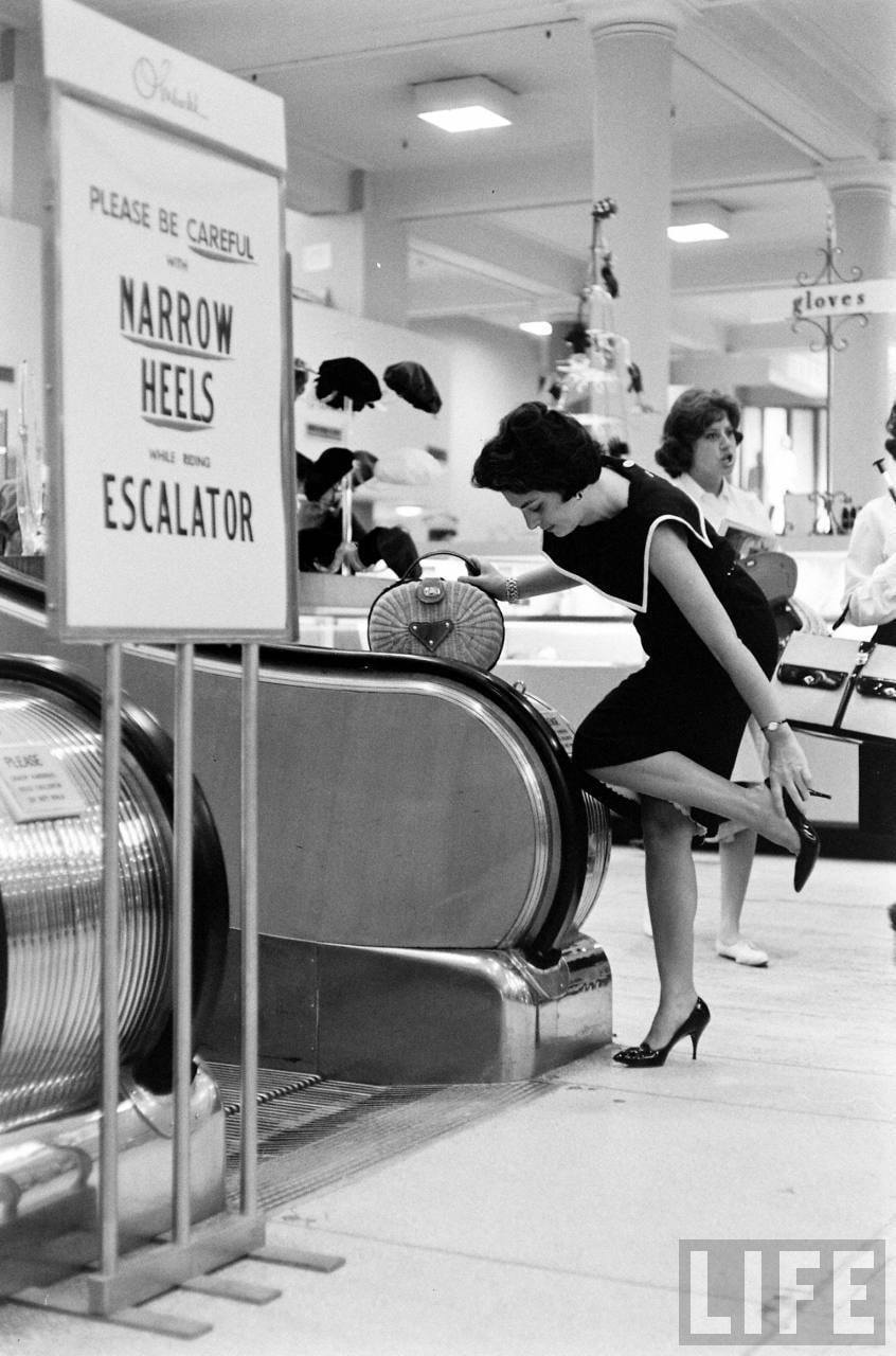 Paramus, New Jersey, 1966 - Women were reminded to remove their high heel shoes before riding the escalator at Gimbel's Department Store.png