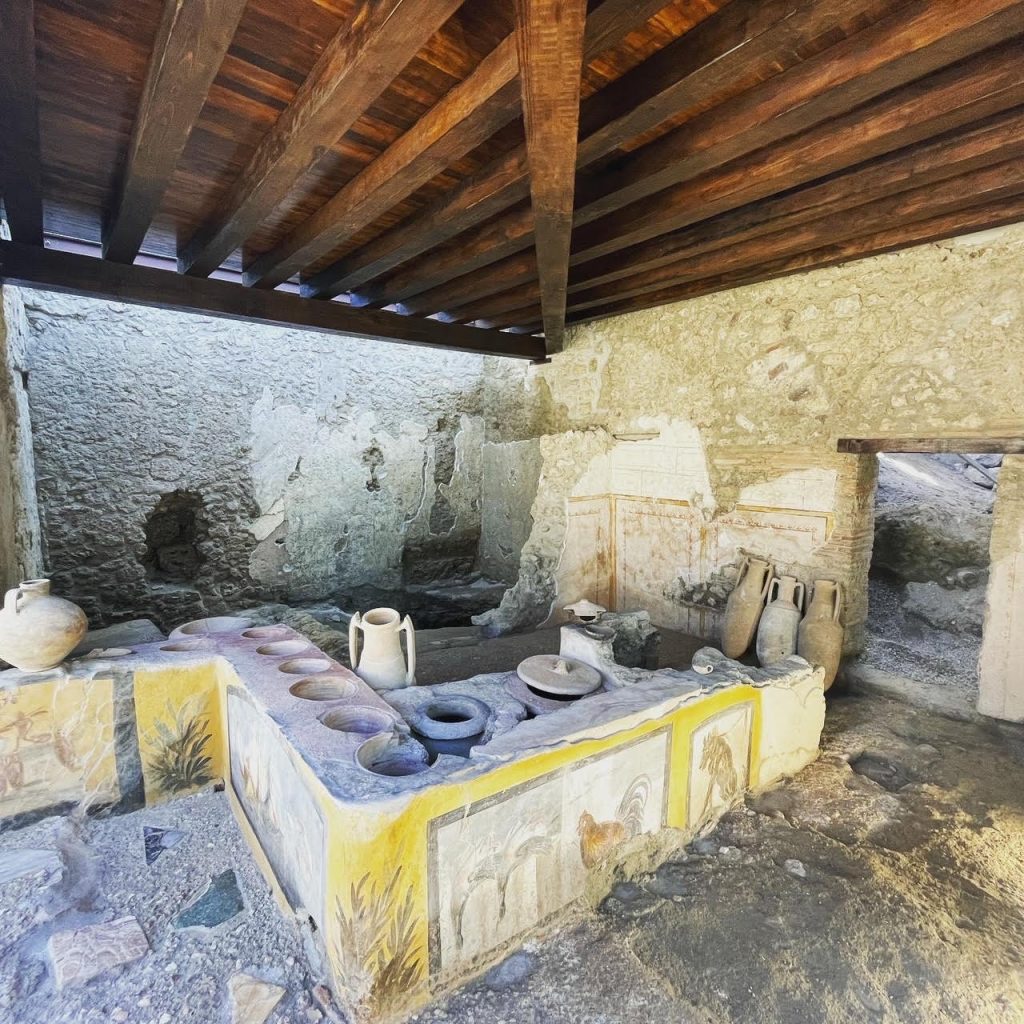 Thermopolium of Regio V. An ancient Roman business that served ready to eat hot food. This restaurant was recently opened to public viewing a couple years ago. From Pompeii A.D.79.jpg