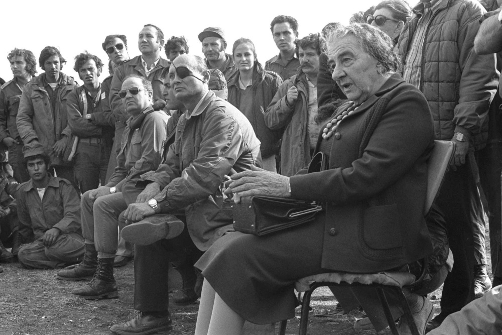 Prime Minister Golda Meir (R) and defense Minister Moshe Dayan meet their troops October 21, 1973 on the Golan Heights during the Yom Kippur War.jpg
