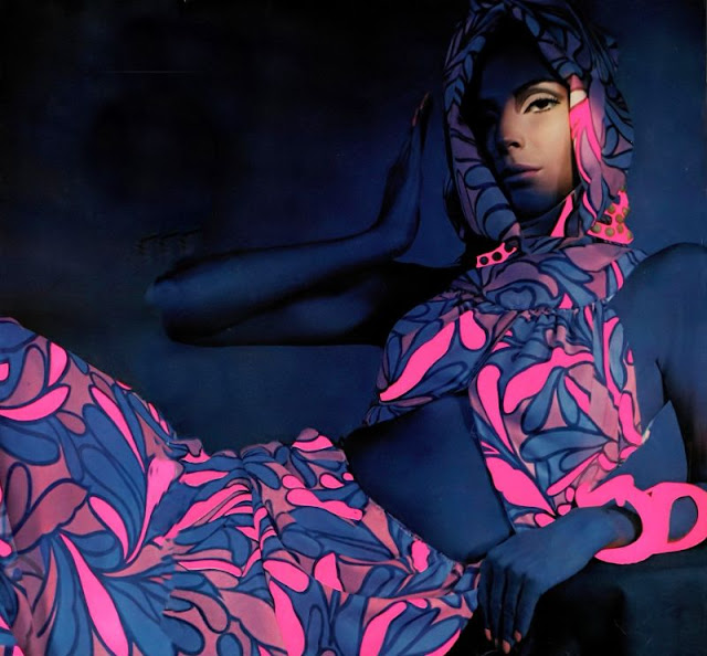 Pam Barkentin in long silk dress of pink and white swirls turning fuschia and blue under black light, open at the midriff and back by Donald Brooks, jewelry by Betty Milham, photo by Hiro, Harper's Bazaar, April 1966.jpeg