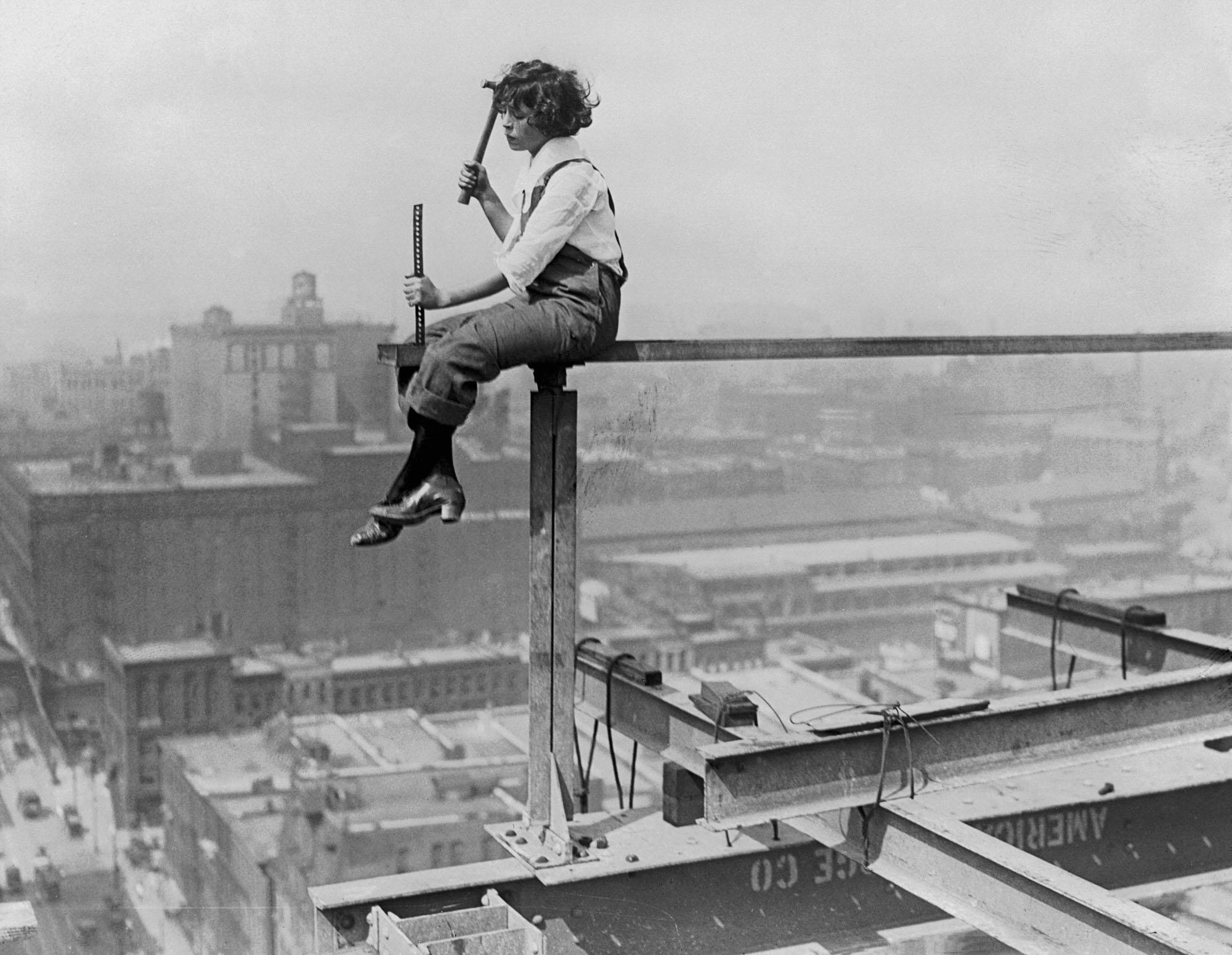 20 year old Bohemian hipster, Lillian Collier, owner of 'The Wind Blew Inn' sitting on a girder, Chicago, early 1920s.jpg
