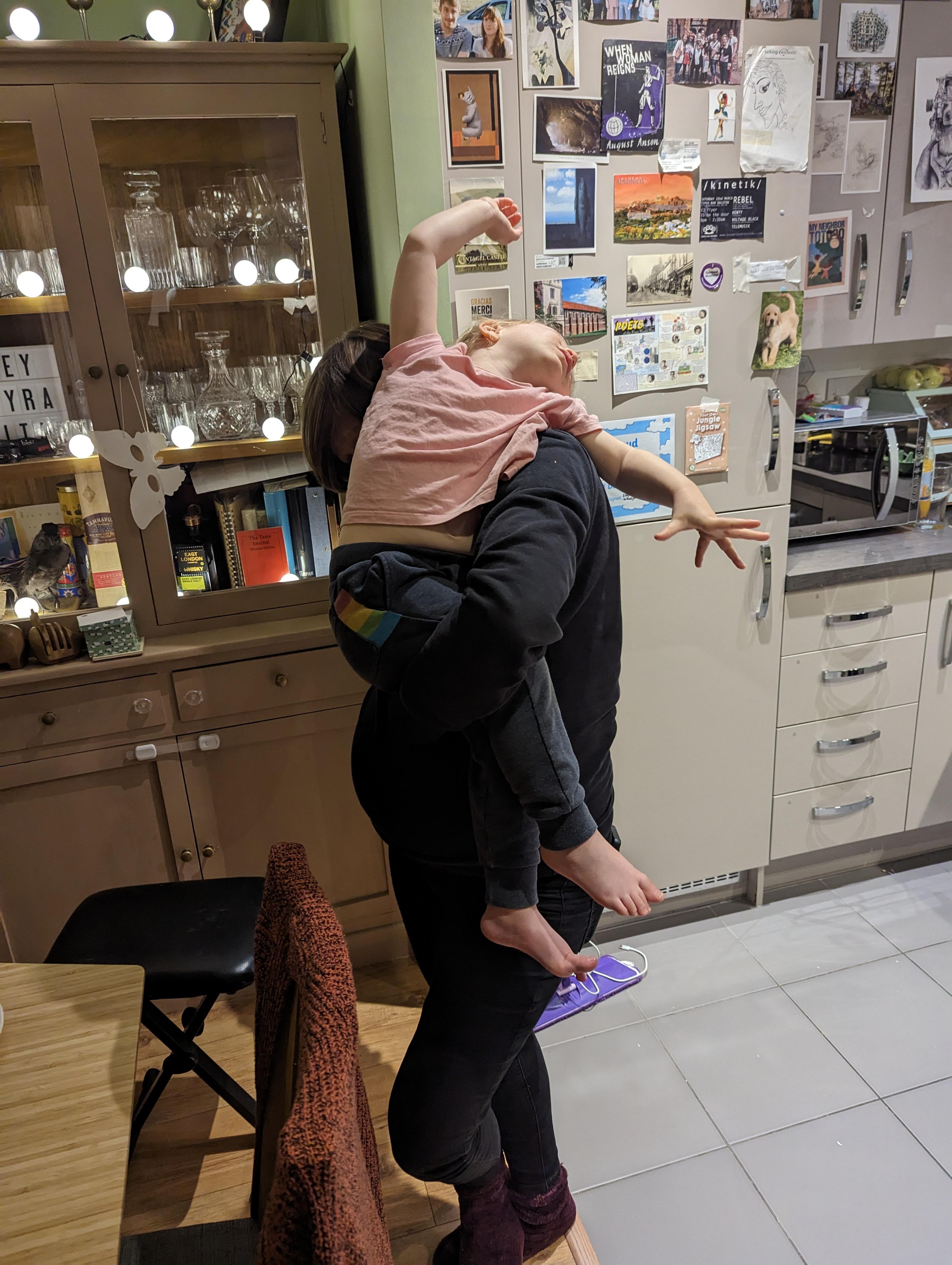trying to make our one year old eat her dinner.jpg