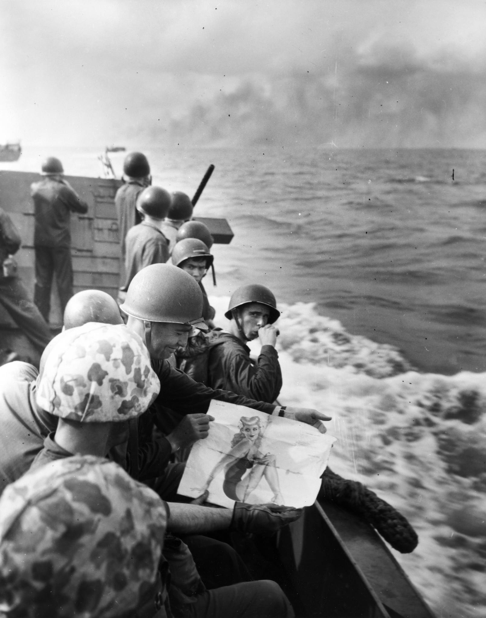'Where Marines Go, Their Pin-ups Go.' U.S. Marines on a landing craft approaching Tarawa, Gilbert Islands. One of the Marines shows a picture of a pin-up girl to the others, 1943. (National Museum of U.S. Navy).jpg