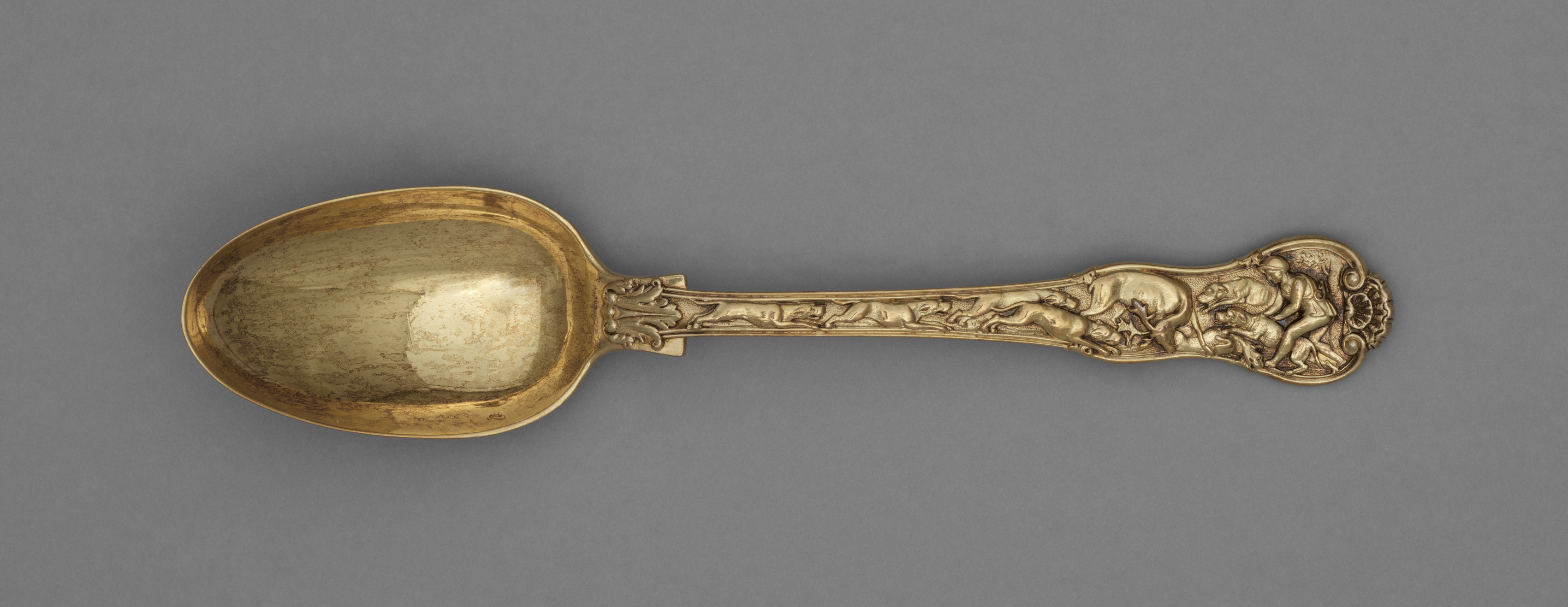 Gilt silver dessert spoon featuring a hunting scene, British, c. 1822.jpg