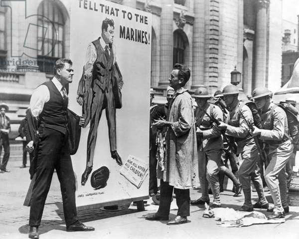 James M. Flagg poses beside his Anti-German propaganda poster during WWI, New York, 1918.jpg